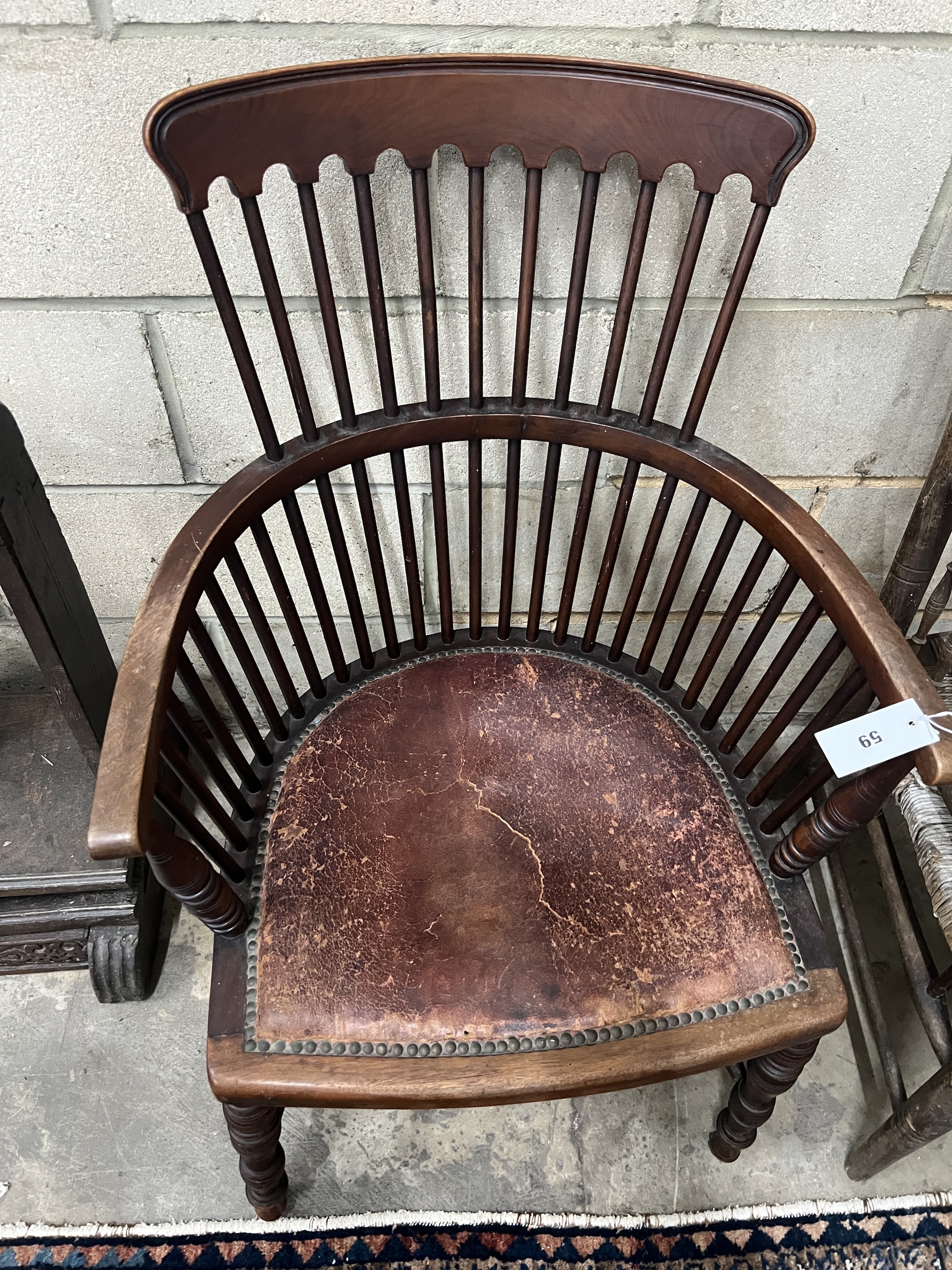 In the Manner of James Peddle for E.W. Godwin - A late 19th century mahogany comb back Windsor armchair, width 57cm, depth 46cm, height 92cm